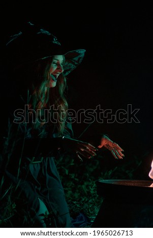A witch woman makes a large fire potion