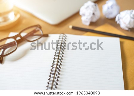Office equipment composition. Notebook, smart phone, pencils, eyeglasses, rubber, laptop on old wooden background. Flat lay, top view