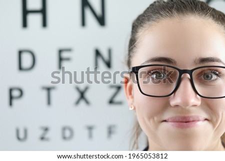 Portrait of woman with glasses on background of ophthalmic table