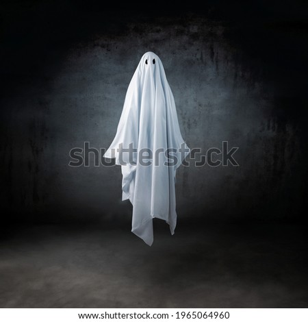 Ghost in a sheet floating in the air Royalty-Free Stock Photo #1965064960