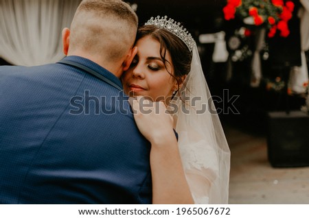 black white photo groom in suit and bride in dress in veil tiara dance together their first wedding dance.  Slavic Ukrainian Russian traditions