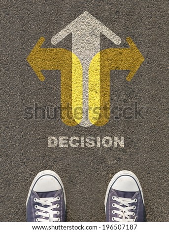 Pair of shoes standing on a road with arrow