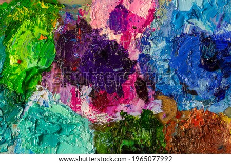 Multicolored oil paint texture macro photography. The artist's palette after a long work, a close-up photo.Colorful oil paint pattern.