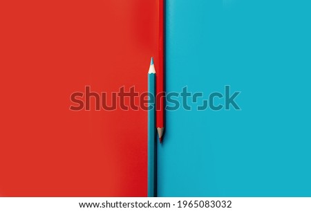 
contrasting image of colored pencils. opposition of red and blue. concept for office, school, writing Royalty-Free Stock Photo #1965083032