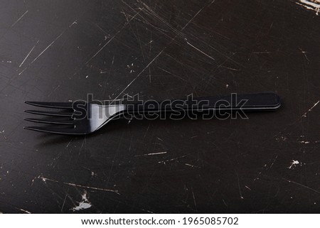 Disposable plastic fork on background
