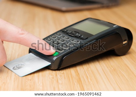 Man hand enters pin code on the terminal for payment.