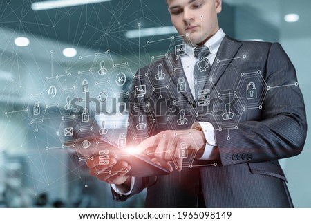 Business man working on a tablet in a network with an interface on a virtual screen.