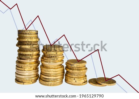 The concept of a falling market, declining stock prices, declining yields and falling prices. Gold coins and declining graphics on an abstract background.
