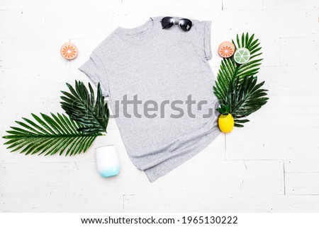 Blank gray unisex t-shirt on white background with summer props, men's-women's apparel mockup