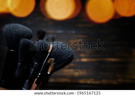 makeup brushes on a dark wooden background.selective focus. High quality photo