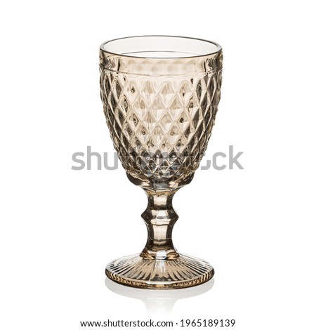 Glass transparent goblet for drinks on a white isolated background.