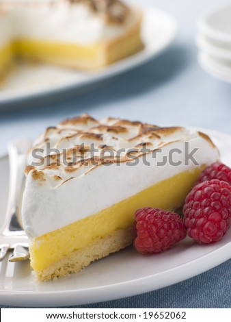 Slice Of Lemon Meringue Pie With Raspberries