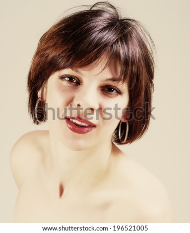 portrait of a pretty young woman with short hair on a light background, age 30 years 