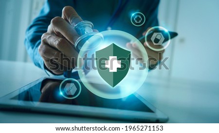 Medical doctor holding stethoscope and mobile, immune system shield for protect your body from danger virus concept. Royalty-Free Stock Photo #1965271153