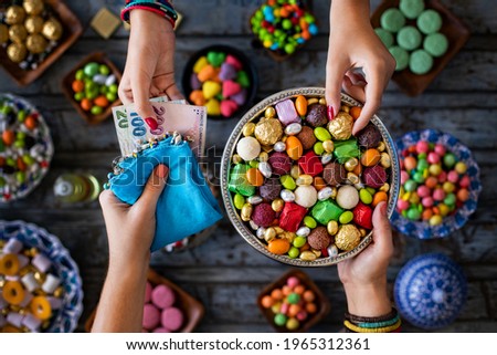 Bowl of candies and chocolate on the wooden table. Many types of candy. 