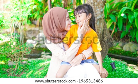 mother and daughter play and have fun in the park