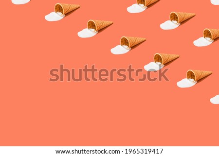A cone with melted ice cream on a bright red background. Minimalistic summer food concept