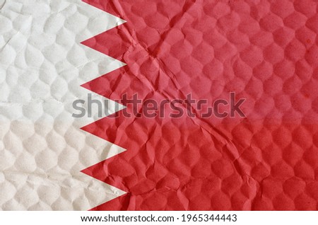 The white and red Bachrein flag on an uneven textured surface. The concept of freedom, the independence of the nation.
