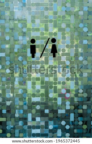 The door with the symbol of the female and male toilets.