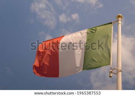Italian flag waving against blue sky
