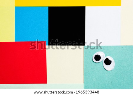 Smileys from toy eyes on hermetic multi-colored background