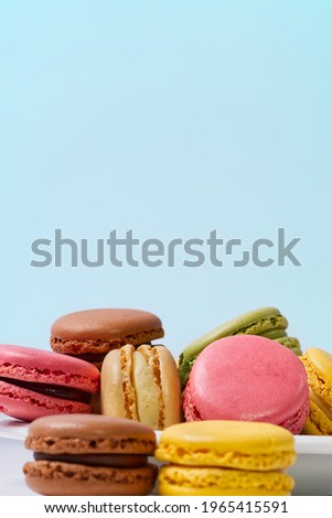 French dessert macaron isolated on blue background. Modern Macarons on colorful background. copy space.