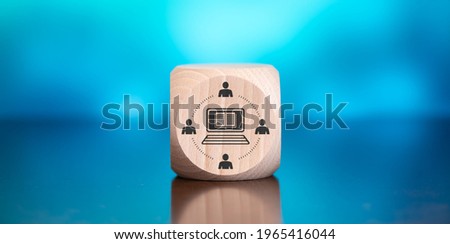 Wooden block with symbol of mooc concept on blue background