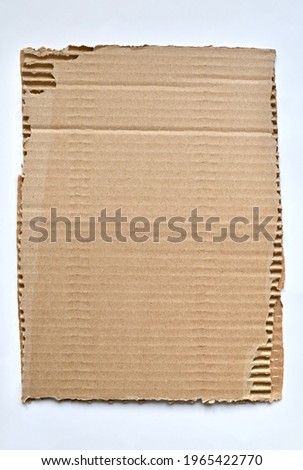 Ripped piece of cardboard. Kraft paper background Royalty-Free Stock Photo #1965422770