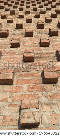 Brick wall. Curly brick elements. Masonry. Horizontal wallpaper.