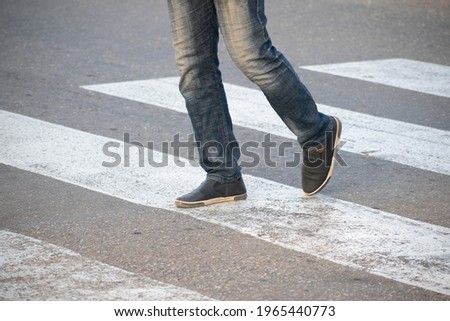 legs crossing a zebra crossing walkway