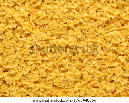 Macro image of many Italian pasta in the form of bows. Abstract background for the designer.