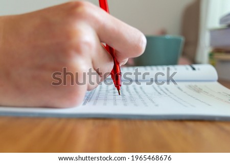 to underline the important sentences with a red pencil while working. efficient working methods. to examine the document, to work by taking notes on the file. working at home office. Royalty-Free Stock Photo #1965468676