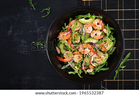 Salad of prawns. Salad of shrimps, arugula, avocado slice, red onion and almond nuts. Healthy concept. Top view, overhead Royalty-Free Stock Photo #1965532387