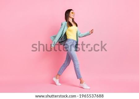 Full body profile side photo charming happy young woman walk empty space wear glasses isolated on pink color background