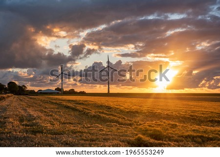 Wind power park at sunset near Neuharlingersiel. Neuharlingersiel is located in East Frisia on the German North Sea coast Royalty-Free Stock Photo #1965553249