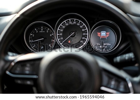 Modern Black Car Dashboard with Door Open Sign and Steering Wheel as Foreground Royalty-Free Stock Photo #1965594046