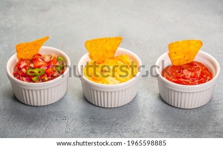 Three mexican salsa, pico de gallo, cheese and spicy tomato sauce