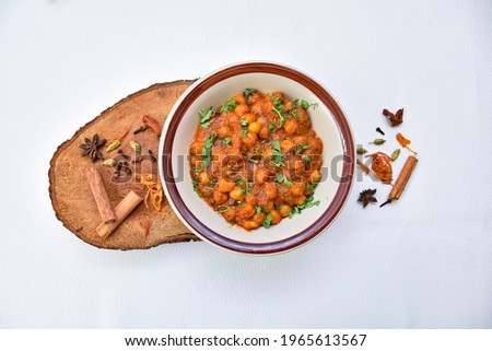  Channa masala, Chole or Chana Masala or Spicy Chickpeas is a traditional North Indian main course recipe and usually served with Bhatura or Roti Naan. Selective focus