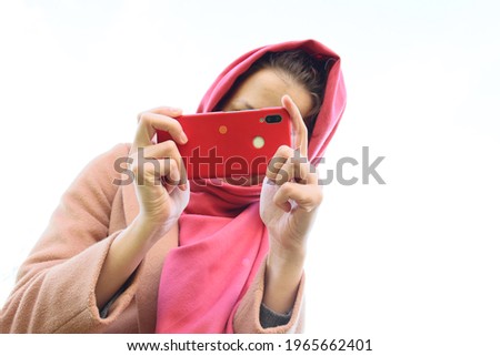 girl taking pictures on a white background