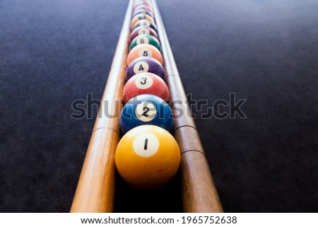 Colored billiard balls arranged in numerical order on the billiard table. Focus selective. Royalty-Free Stock Photo #1965752638