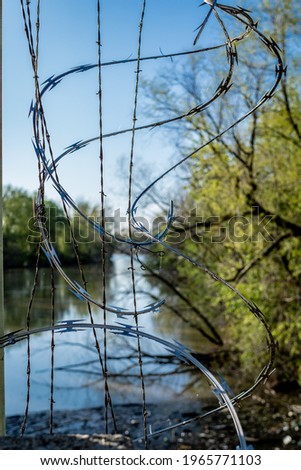 Barb wire with river background