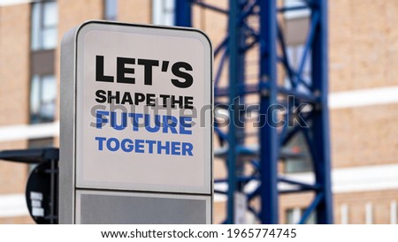 Let's Shape The Future Together sign in a city setting under construction
