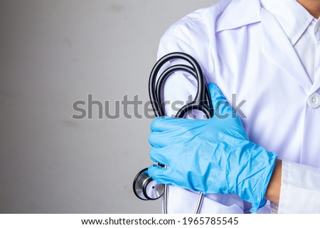 doctor or nurse standing holding stethoscope and red heart, 
Concept: care covid-19 corona virus disease medical protection ,Female in her Medical  Stethoscope, clinic healthcare professionalism 