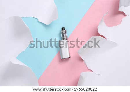 Vaping device on blue-pink background with torn paper. Concept art. Pastel color trend. Creative layout. Minimalism. Top view