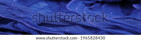 Blue silk fabric with lurex. Glossy texture background, satin background, luxurious fabric, elegant pattern, colorful abstract, colorful velvet, shredded macro.