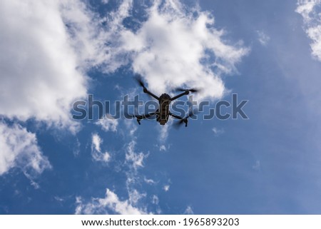 A drone against cloudy sky