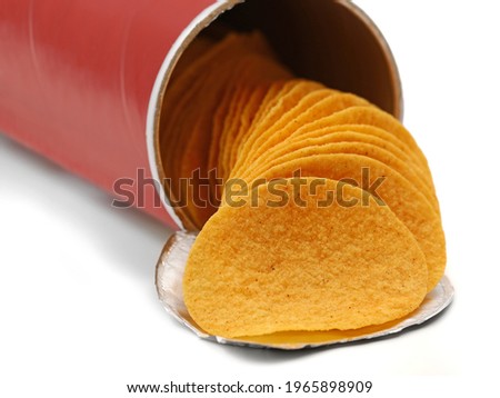 stacked crisps falling out from red cardboard tube, paprika flavoured potato chips in can isolated on white background Royalty-Free Stock Photo #1965898909
