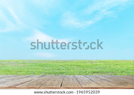Old wooden boards, lawn and sky are perfect for background use.