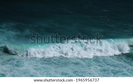 Rolling wave through the ocean. The nature never sleeps, wave keeps moving along the times. Blue color of the ocean brings calming vibes.