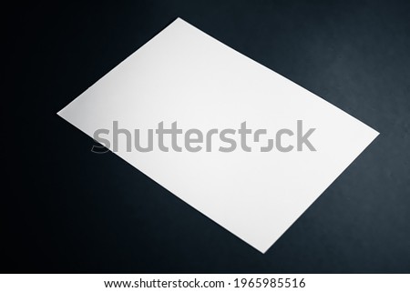 Blank A4 paper, white on black background as office stationery flatlay, luxury branding flat lay and brand identity design for mockup.